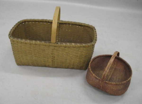 TWO GOOD BASKETS.: Large rectangular splint basket with fixed handle in old pale mustard paint over earlier mustard. Minor loss. 23"l. 15"w. 14"h. including handle. The other basket is finely ribbed with tightly woven n