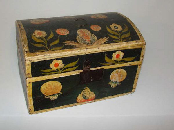 DECORATED DOME TOP BOX. American, 19th Century. Pi: DECORATED DOME TOP BOX. American, 19th Century. Pine with original dark blue paint, ivory trim and ivory and green flowers and stylized designs. Wire bale handle, staple hinges and original hasp. Some