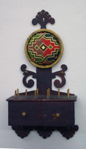 HANGING TWO-DRAWER SEWING BOX WITH PAINTED DECORAT: HANGING TWO-DRAWER SEWING BOX WITH PAINTED DECORATION. Pine with old red paint and gold detail. The backboard has leaves and scrollwork with small brass hooks. Drawers have wooden pulls and ten posts
