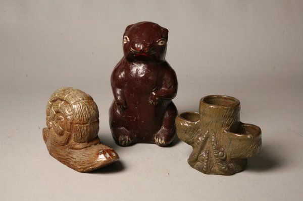 THREE PIECES OF SEWERTILE. American, 20th Century.: THREE PIECES OF SEWERTILE. American, 20th Century. Snail initialed "RLW" for Robert Wilson, 8 1/2"l.; a painted groundhog, 9"h. and a small tree stump planter with greenish glaze. 5"h.