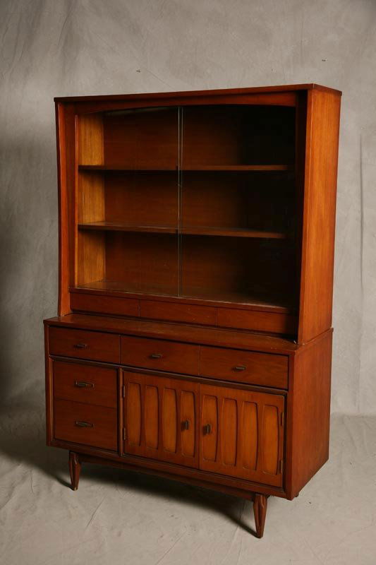 MAPLE CHINA CABINET. 1950's Art Moderne design wi: MAPLE CHINA CABINET. 1950's Art Moderne design with three drawers, two lower doors and glass sliding upper doors. Signed Hooker Furniture Co, West Virginia, possibly designed by Russel Wright. 71.5"h.
