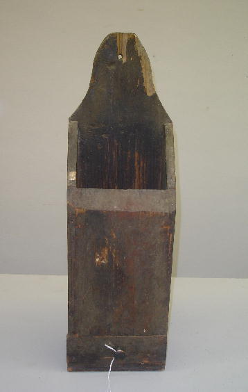 PIPE BOX IN OLD SURFACE. Pine with old brown over: PIPE BOX IN OLD SURFACE. Pine with old brown over red paint. A single drawer in the base retains the original brass pull. High arched tab crest with chips. A mixture of nails. 21 1/2"h.6 1/2"w. 4 1/2"