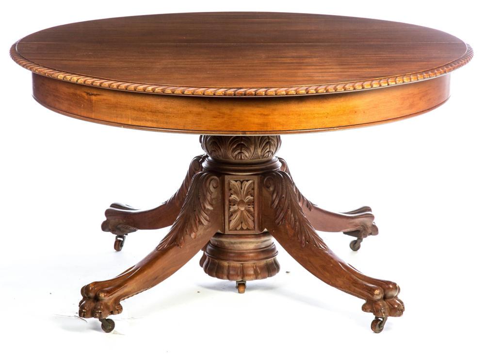 ROUND PEDESTAL DINING TABLE.: ROUND PEDESTAL DINING TABLE. American, late 19th century, Southern gum. Top with gadrooned edge, pedestal with acanthus leaf carving, and paw feet. 30.75"h. 55" diameter, includes center leg but no le