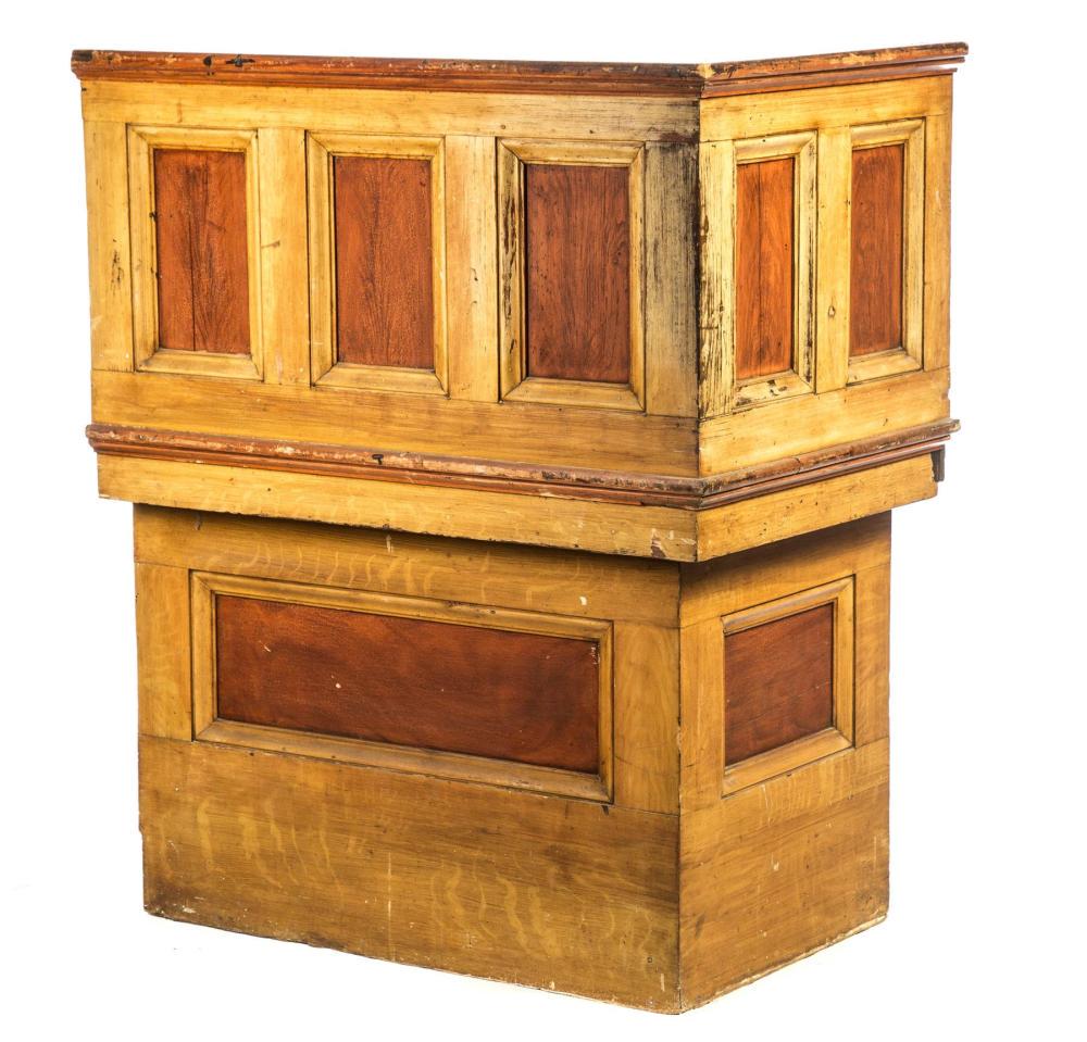 AMERICAN DESK.: AMERICAN DESK. Mid 19th century, pine. Reputedly a shipping line paymaster's desk. One-piece built in desk with high paneled side and back and slant lid. Nailed drawer below. Original grain paint. Ins
