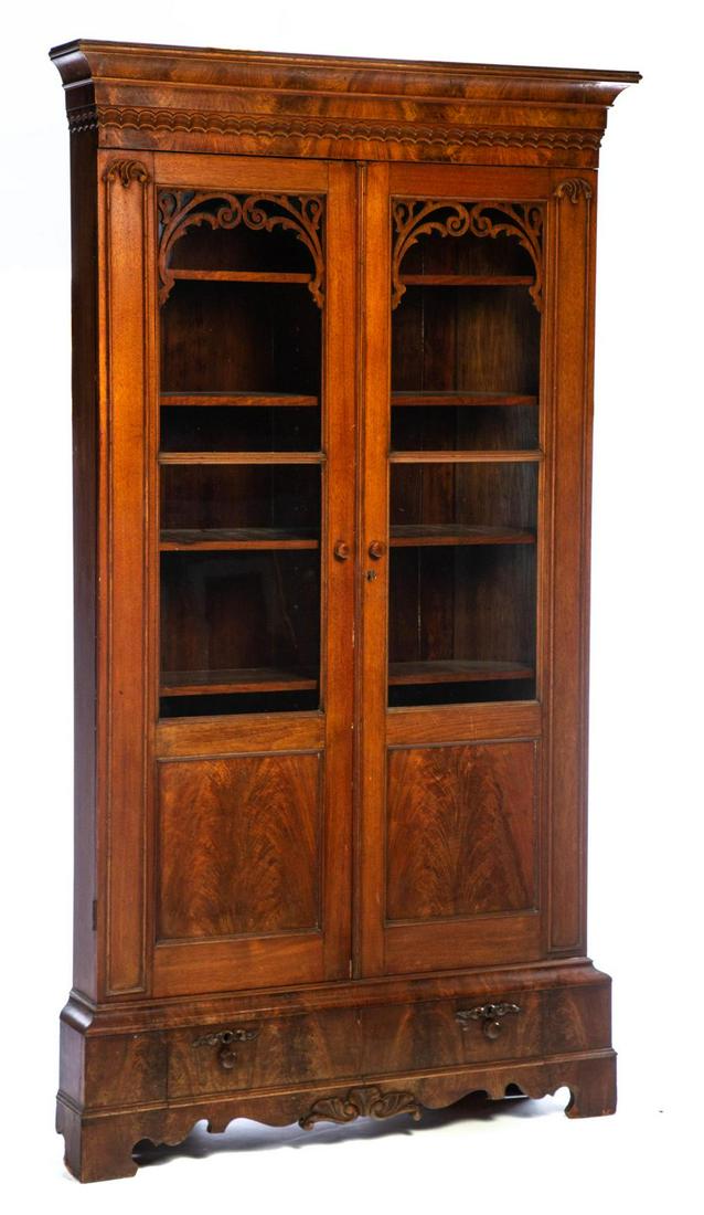 VICTORIAN CINCINNATI CORNER BOOKCASE.: VICTORIAN CINCINNATI CORNER BOOKCASE. American, 3rd quarter-19th century, walnut and burled walnut with poplar secondary. Cove molded cornice, wave molded frieze, door with jigsaw cut tracery, two gla