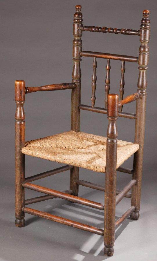 TURNED GREAT CHAIR. Probably American and pos: TURNED GREAT CHAIR. Probably American and possibly 17th century, in ash. With three turned spindles, ball finials on the posts, and a double box stretcher. Retains an old, green paint. Imperfections.