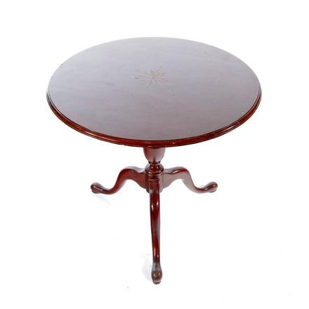QUEEN ANNE STYLE TEA TABLE.: American. Mid 20th century. Mahogany with routed edge and inlaid rose compass, turned balister column, snake legs and pad feet, 29.5"h. 30" diameter.