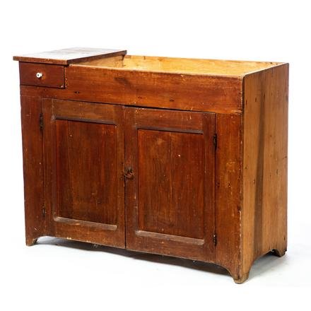 COUNTRY DRY SINK.: American. 2nd half-19th century. Poplar and pine, dovetailed overlapping drawer to left of well, two lower single panel doors, solid ends and simple cut out feet, 33"h. 42.5"w. 19"d.