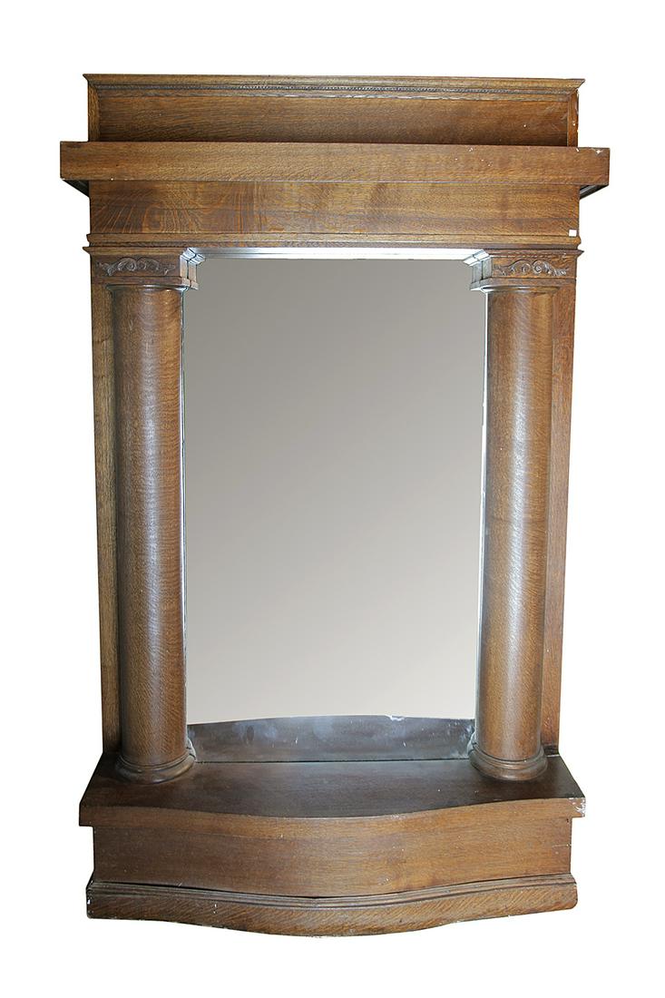 ARCHITECTURAL HALL MIRROR.: American ca. 1900. Quarter sawn oak, heavy stepped cornice, half columns with applied carvings on capitals and bowed base with simple base molding. 96"h 58"w. 13"d.