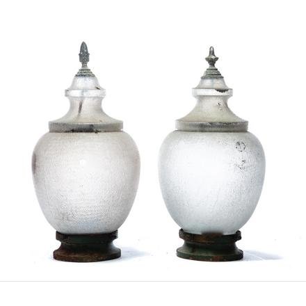 TWO GENERAL ELECTRIC STREET LIGHT GLOBES WITH CAST IRON: American. Mid 20th century. Textured glass and different finials, in two sections and one with arrow point finial in embossed, "G.E. 1127", 31"h.