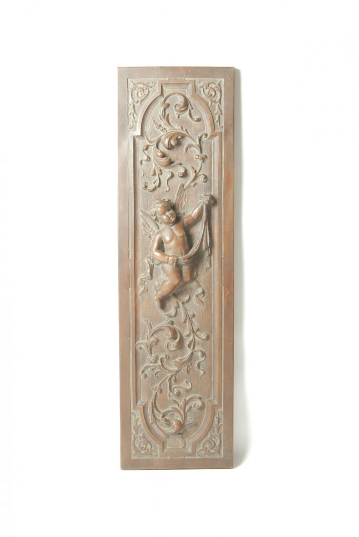 POTTERY PANEL WITH CHERUB.: European, late 19th century. Molded relief of foliage and full-bodied cherub, 41.25"h. 12"w.