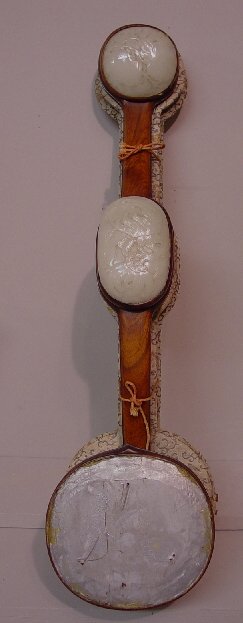 UNUSUAL ORIENTAL SCEPTRE. Curved, laminat: UNUSUAL ORIENTAL SCEPTRE. Curved, laminated wood with carved key edge design. Three thinly carved disks with flowers and fruit are probably mutton fat jade. Originally tied on, they are now glued (lar