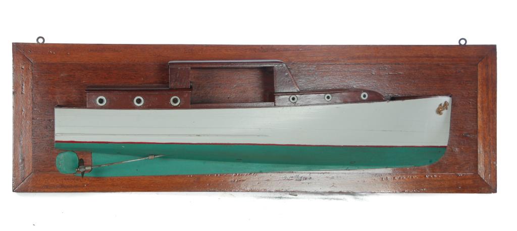 AMERICAN CABIN CRUISER HALF MODEL.: Ca 1940. Carved and painted wood in original green and cream, in the Chris-Craft style. On a wood mount. 11"h. 36"w. Ex John D. Wahl (New Hampshire); the collection of Susan and Mark Laracy (New York)