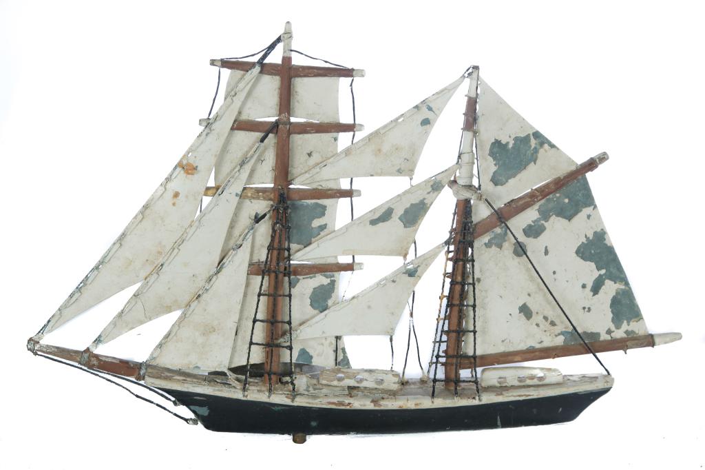 FRANK ADAMS SCHOONER WEATHERVANE.: Martha's Vineyard, Massachusetts, ca 1930s. Wooden hull with sheet zinc sails and cord rigging. Original paint is worn. Age splits. 15.5"h. 24"l. The collection of Susan and Mark Laracy (New York).