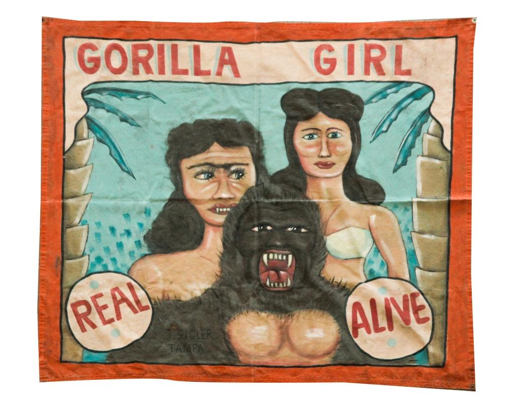 AMERICAN SIDESHOW BANNER BY SIGLER.: Ca 1950s. Original paint on canvas. "Gorilla Girl, Alive". Signed "J. Sigler, Tampa". Wear. 53" x 79".