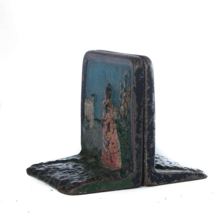 PAIR OF AMERICAN CAST IRON BOOKENDS.: First quarter - 20th century. Relief of woman in a garden with original paint. Wear. 4.25"h. The collection of Susan and Mark Laracy (New York).