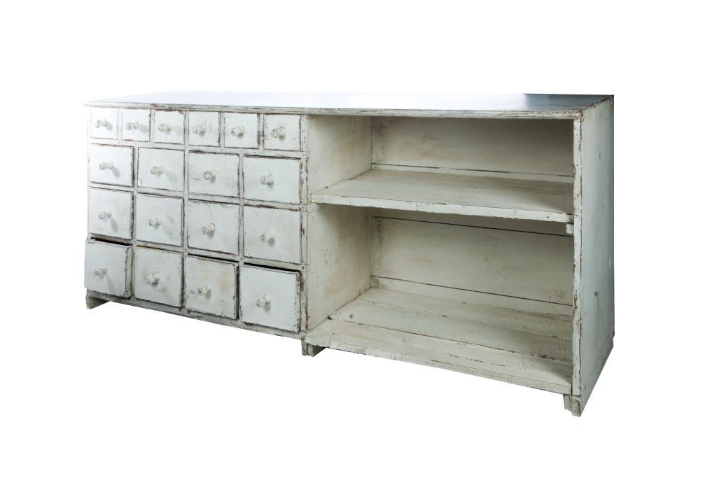 SWEDISH COUNTRY SIDEBOARD.: Third quarter - 19th century, pine. Simple form with eighteen dovetailed drawers and removable shelves. Old white paint. Wear. 32"h. 76.5"w. 19.5"d. Ex Albert Hadley (New York); the collection of Susa