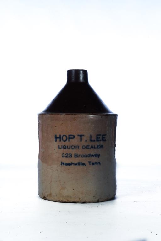 TENNESSEE STONEWARE JUG.: Late 19th century. Stenciled cobalt merchantâ€™s label â€œHop T. Lee Liquor Dealerâ€¦Nashville, Tenn.” Lip chip. 9.25”h.