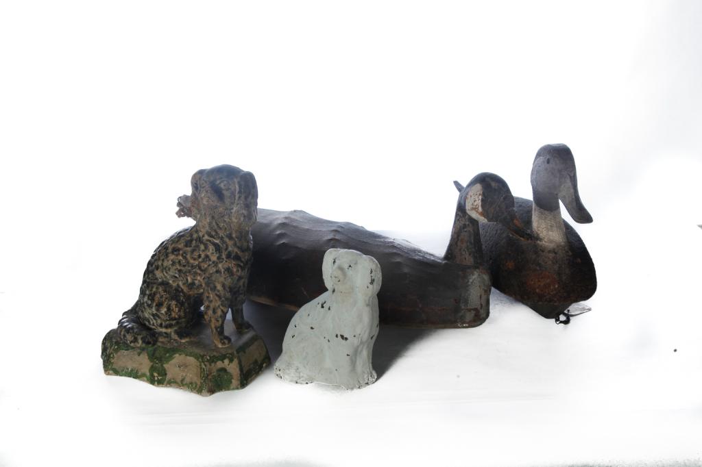 TWO DECOYS AND TWO POTTERY SPANIELS.: American, 2nd half 19th-mid 20th century. Redware dog with late white paint, 7"h. and white clay dog on base with old paint. 11.5"h. Together with a canvas body Canada goose, 24"l, and a cork body pin