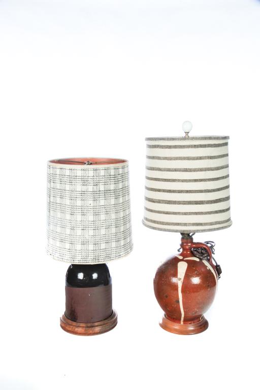 TWO AMERICAN POTTERY JUG LAMPS.: Mid 19th century. Galena ovoid jug with running ivory glaze, 20.5”h. overall. And redware with brown glaze, 22”h. overall. Electrified.