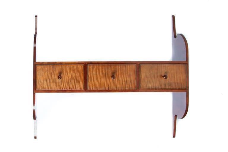 SHAKER STYLE HANGING SHELF.: American, late 20th century, cherry and tiger maple with pine secondary. Shaped ends and three dovetailed drawers with beaded fronts. 32.75"h. 38"w. 7.75"d.
