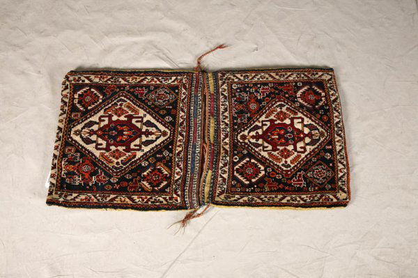 ORIENTAL SADDLE BAGS. Central crimson medallion w: ORIENTAL SADDLE BAGS. Central crimson medallion with navy blue, rust orange and white borders. Tightly woven mustard yellow and rust red backing. 20 1/2"h. 21"w.