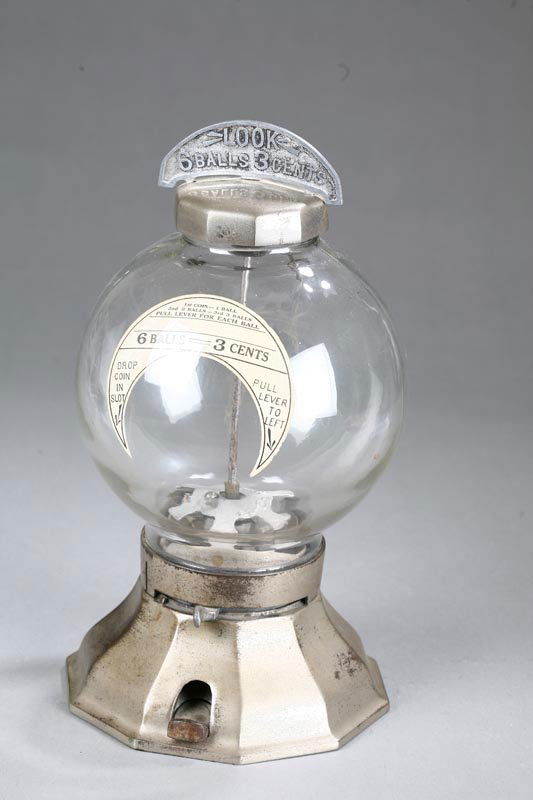 LOOK" BUBBLE GUM MACHINE. Metal and glass gumball: "LOOK" BUBBLE GUM MACHINE. Metal and glass gumball machine has original labels and marked "6 balls 3 cents"; 13 1/2" high.