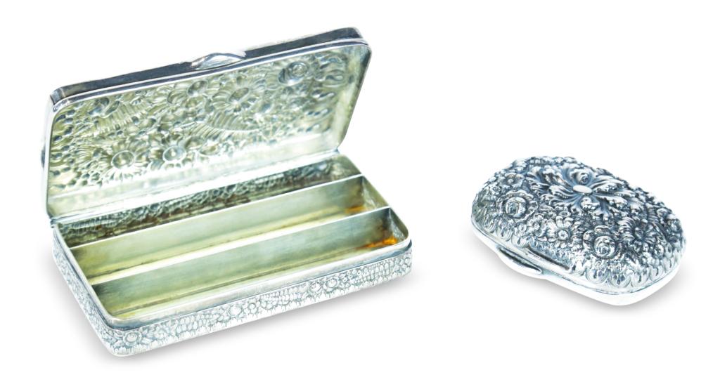 TWO TIFFANY AND CO. "REPOUSSE" STERLING BOXES.: American, ca. 1900. One from a dresser set for a bar of soap, 1.5"h. 3.25"w. 2.5"d. And one with a three-section fitted interior, 1.25"h. 5.75"w. 3.25"d. Approx. 13 ozt.