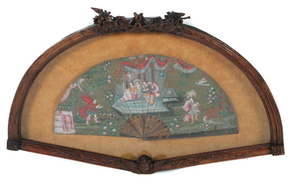 CONTINENTAL DECORATED LEATHER FAN.: Possibly Italian, 18th century, gouache on thin leather. Tortoise shell handle and gilt decorated ribs. Hand decorated classical scene with three women on a portico watching an archer and a musician.
