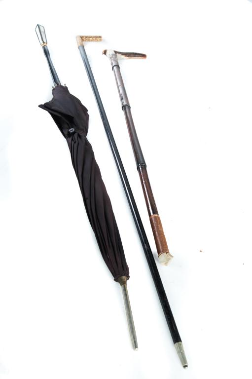 WALKING STICK, CROP AND PARASOL.: American, 1st quarter 20th century. Black parasol with mother of pearl handles, 34.5"l., walking stick with gold filled handle and inscribed name "Leybt", 37"l. and a riding crop with antler handle an