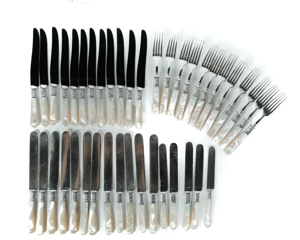 GROUP OF MOTHER OF PEARL FLATWARE.: Early 20th century. Stainless with mother of pearl handles. Set of twelve matching forks and knives marked "Northampton". And sixteen assorted knives, some with faint marks, one marked "Montgomery Bro