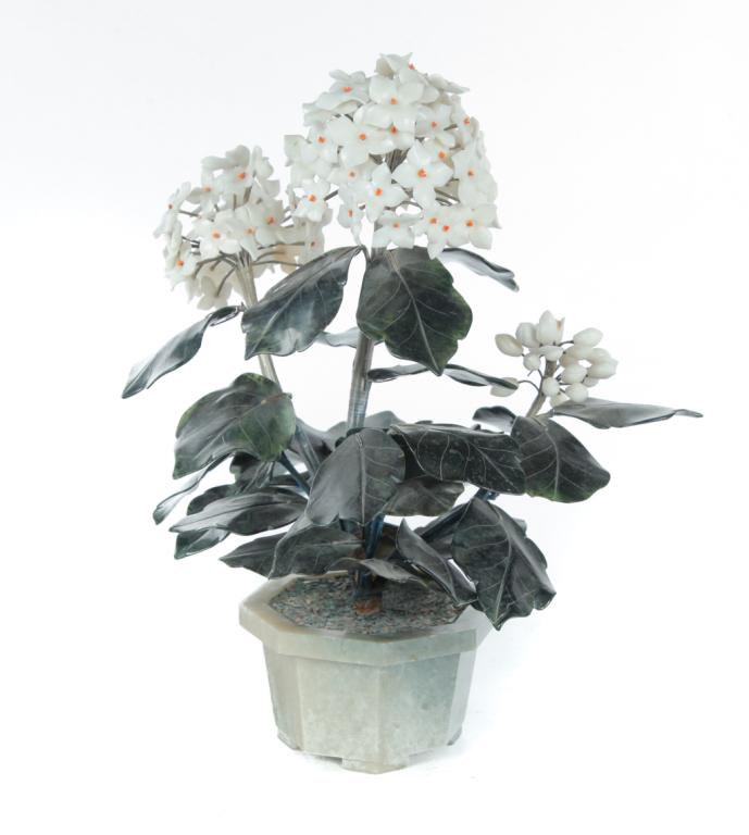 CHINESE JADE FLOWER GARNITURE.: Second half-20th century. Octagonal planter with carved leaves and white stone petals. 15.5"h.