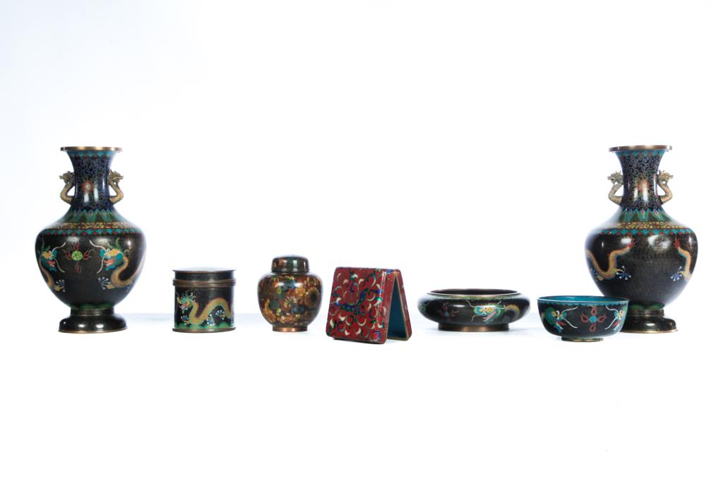 SEVEN PIECES OF CHINESE CLOISONNE.: Twentieth century. Five pieces have yellow dragons on black grounds. Pair of vases stamped "China", 10"h., two bowls, 4.5", 6.25"d. and a covered canister, 3.25"h. Together with lidded box, red with b