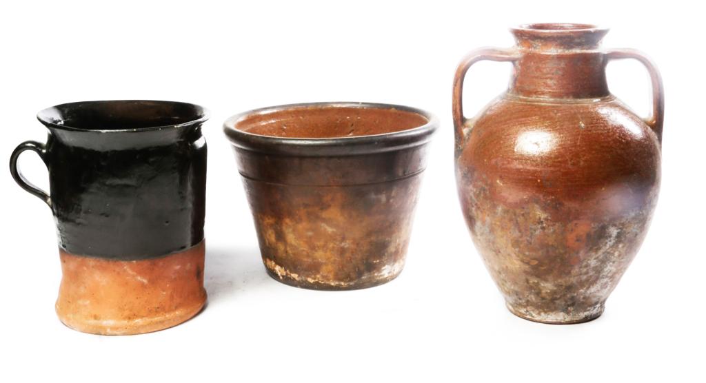 THREE PIECES OF EUROPEAN REDWARE.: Second half 19th century. Large bowl with interior glaze, 7"h., crock with handle and interior glaze, 8"h., and double handled jug. 11.5"h.