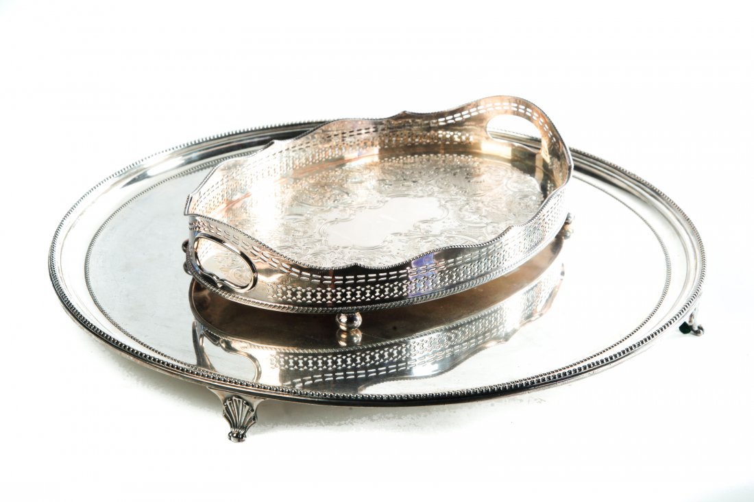 TWO FOOTED SILVERPLATED TRAYS.: England, 19th and 20th centuries. A large circular with beaded edge and shell feet, 1.5"h. 20"dia. And a gallery tray with seven branch candelabra mark, and "England" on reverse, reticulatred and bead