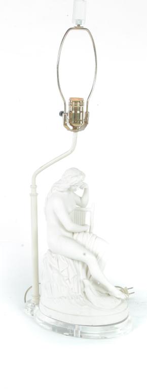 PARIAN FIGURE OF A SEATED FEMALE NUDE.: England, 3rd quarter 19th century. She is slightly draped with a serpent at her feet. Mounted on a Lucite base which is an electrified table lamp. 14"h. Plus harp.