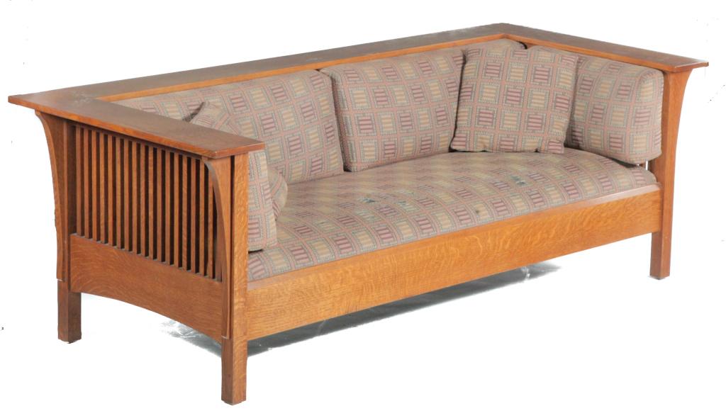 STICKLEY ARTS AND CRAFTS STYLE SOFA.: American, late 20th century. Quarter sawn oak with slat sides and back, square legs, and applied carved decoration. 17" seat ht. 30"h. 84.5"w. 37.5"d.