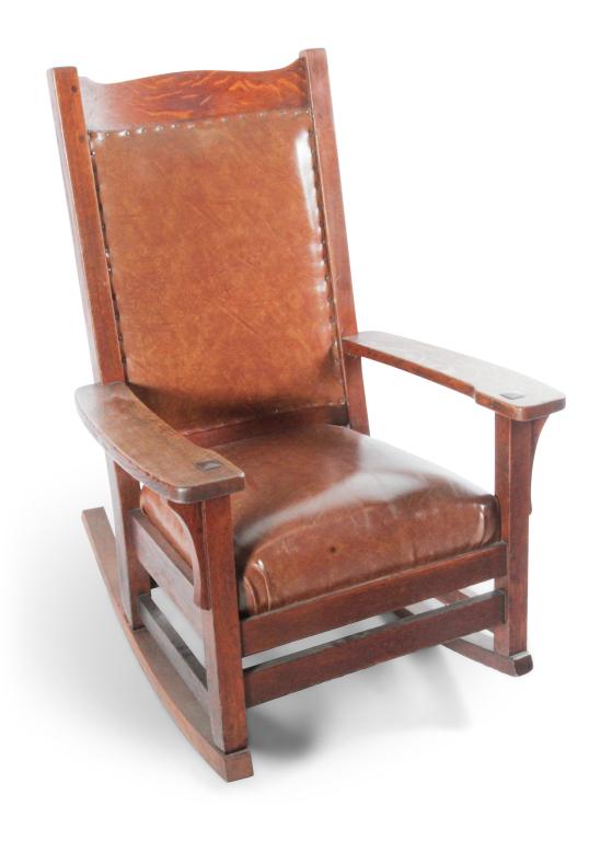 MISSION OAK ROCKER.: American, 11st quarter 20th century. Quarter sawn oak with leatherette upholstered back and seat, pegged and mortised construction with old alligatored finish. 18"seat ht. 39.5"h.