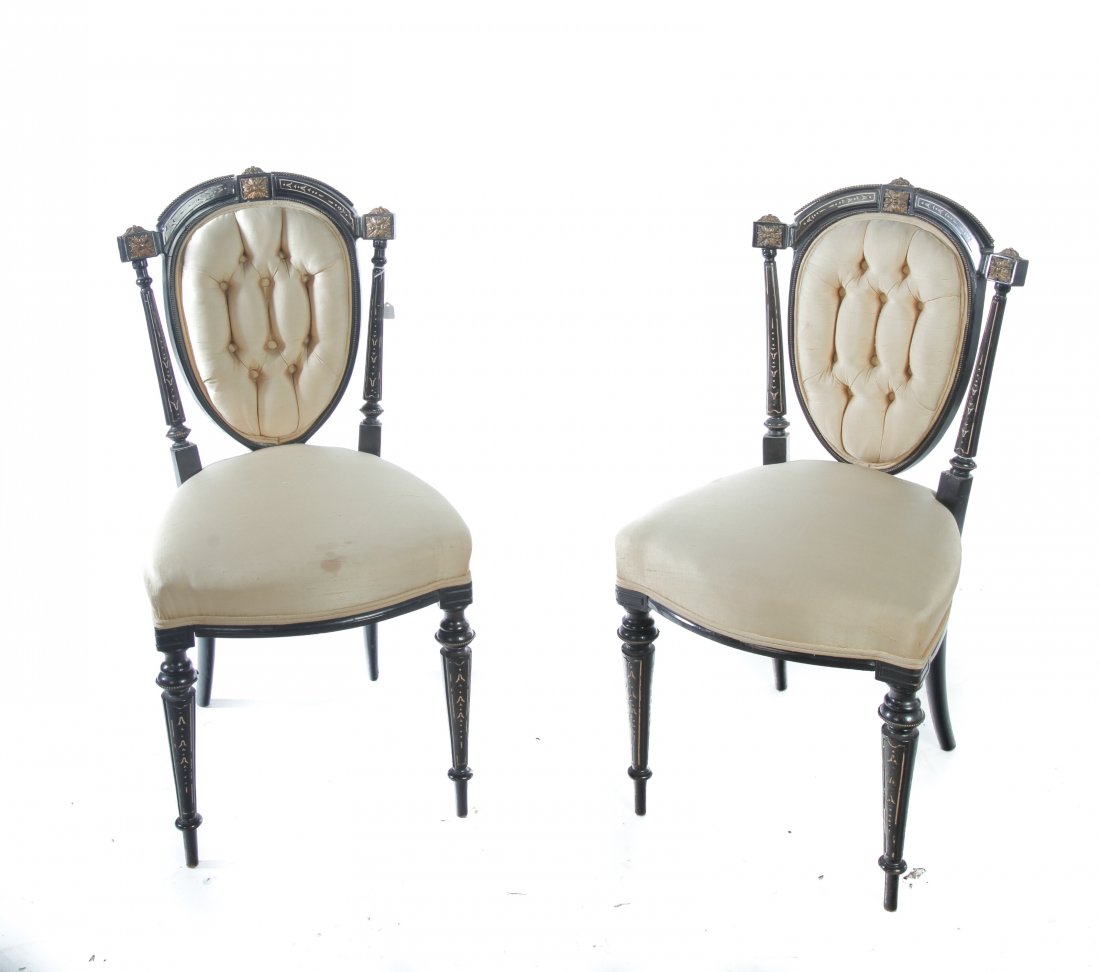 PAIR OF VICTORIAN EBONIZED SIDE CHAIRS.: American, 3rd quarter 19th century. Mixed woods with black finish, arched crest, fluted stiles and front legs, white inlays, bead brass trim, gold leaf medallions, and upholstered seats with tufted ba