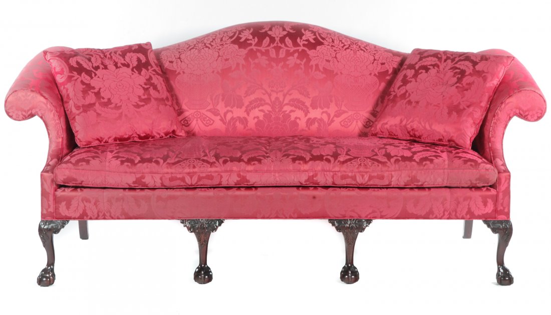 STICKLEY CHIPPENDALE STYLE SOFA.: American, late 20th century. Mahogany frame, camel back, rolled arms, detached cushion, and four front legs with carved knees and ball and claw feet. 20" seat ht. 40"h. 78"w.