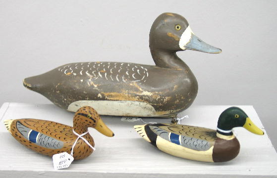THREE CARVED WOODEN DUCK DECOYS. A pair of miniatu: THREE CARVED WOODEN DUCK DECOYS. A pair of miniature carved hollow body mallards by "Eugene Wertz, Pekin, Ill". 7"l. Bluebill in old brown, white and blue paint signed "Pickert" on the base. Lead keel