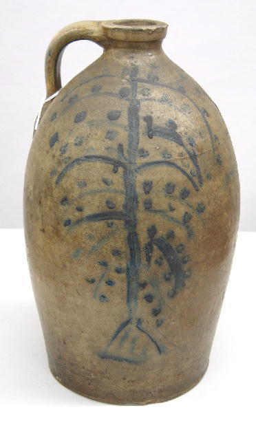 STONEWARE JUG. To one side is an unusual tree desi