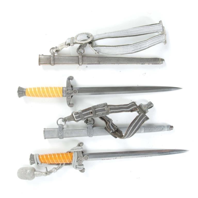 TWO WWII GERMAN WKC, SOLINGEN DRESS DAGGERS: TWO WWII GERMAN NAZI WKC, SOLINGEN DRESS DAGGERS. Germany, 2nd quarter-20th century. Both with Bakelite handles, Imperial Eagle guard with swastika below, and sheath, 15.75"l. And 16.5"l.