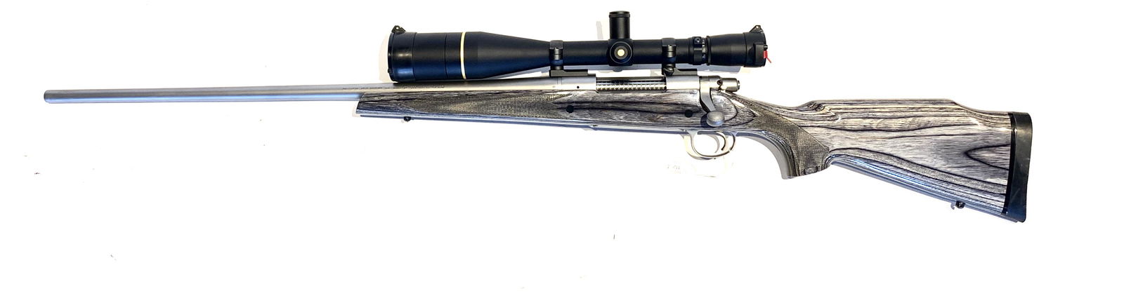 *REMINGTON ARMS MODEL 700 LSS LH .300 RIFLE: REMINGTON ARMS MODEL 700 LSS LH .300 BOLT-ACTION RIFLE. American, 21st century. Left-hand bolt-action with stainless steel barrel and grey tinted laminate Monte Carlo wood stock. 26" barrel length, 46