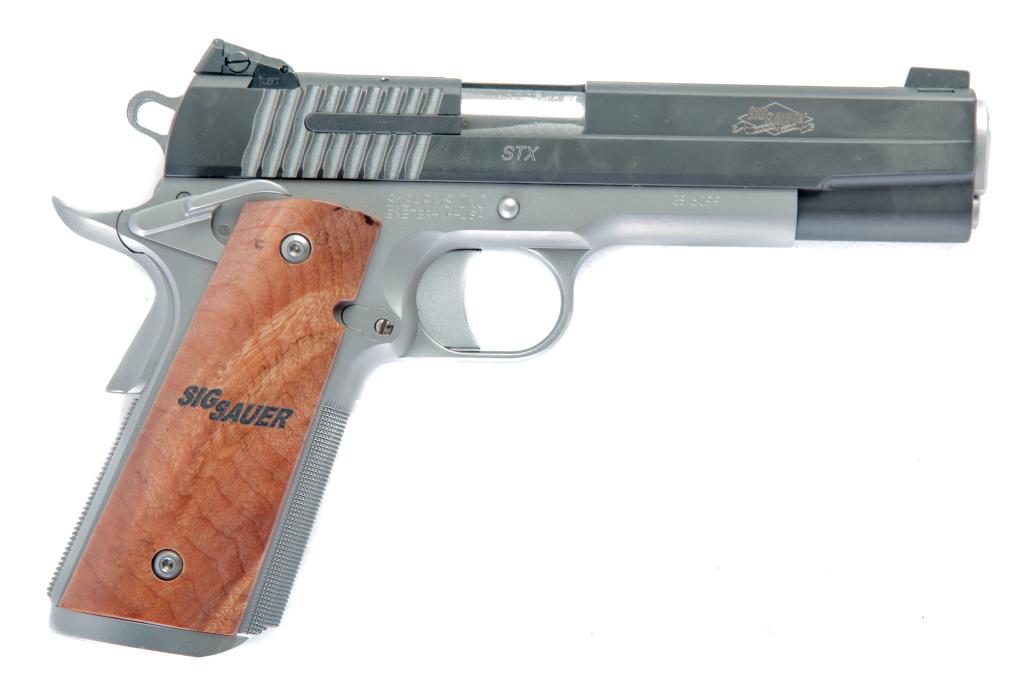 *SIG SAUER 1911 STX .45 ACP SEMI-AUTOMATIC PISTOL: SIG SAUER 1911 STX .45 ACP SEMI-AUTOMATIC PISTOL. American, 21st-century. Two-tone finish with Nitron slide over natural stainless frame, match grade barrel, and custom wood grips. 5" barrel length, 9