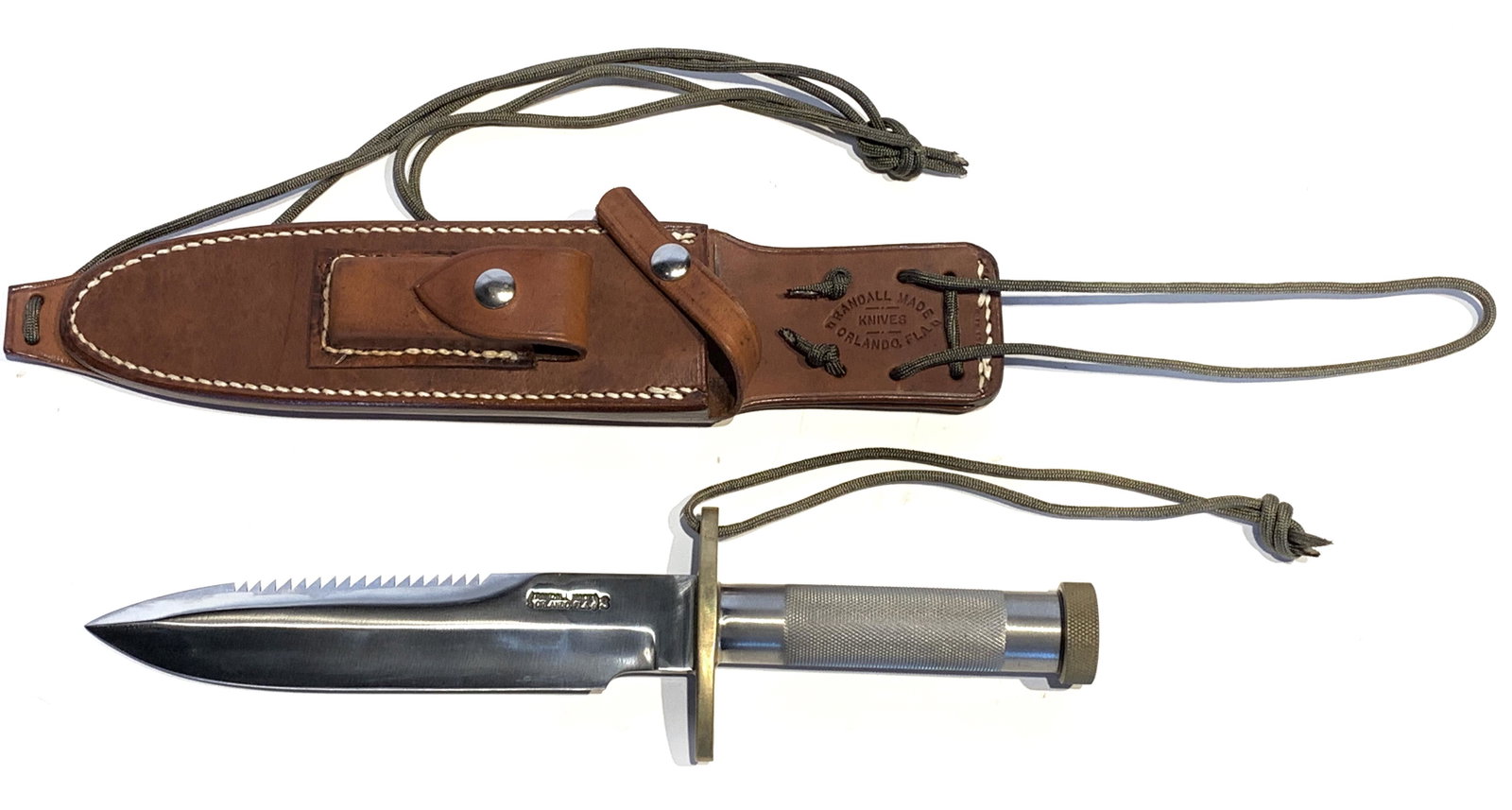 RANDALL KNIVES NO. 18 - 7.50" BLADE: RANDALL KNIVES NO. 18 - 7.50" BLADE. 1" diameter knurled stainless steel handle, threaded brass butt cap, sawtooth edge on top, with brass oblong hilt. 12.5" overall length. Includes Randall leather s