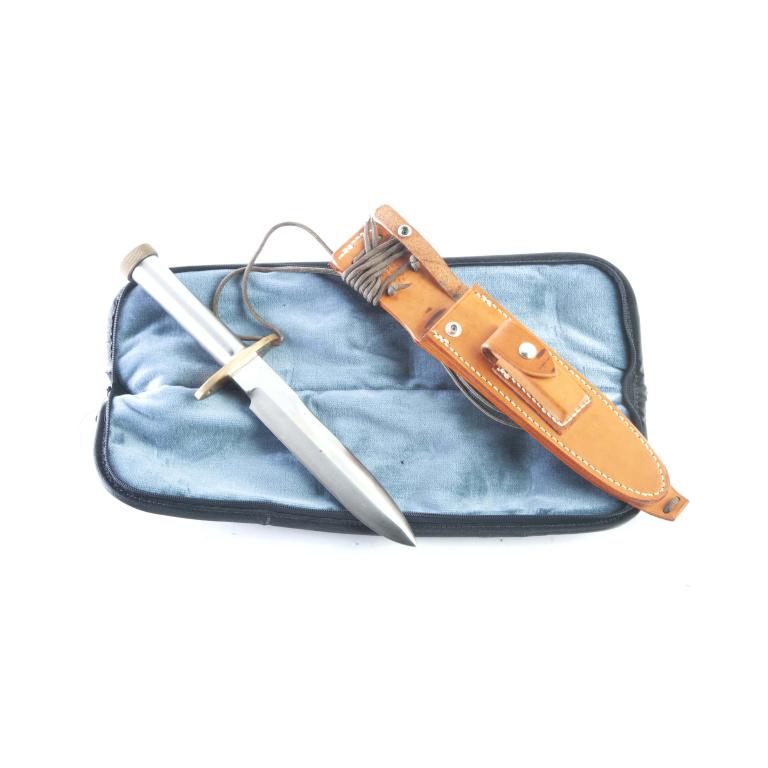 RANDALL KNIVES MODEL 18 - 7.5" BLADE: RANDALL KNIVES NO. 18 - 7.50" BLADE. 1" diameter stainless steel handle, threaded brass butt cap, with brass oblong gaurd. 12-7/16" overall length. Includes Randall Knives leather sheath.