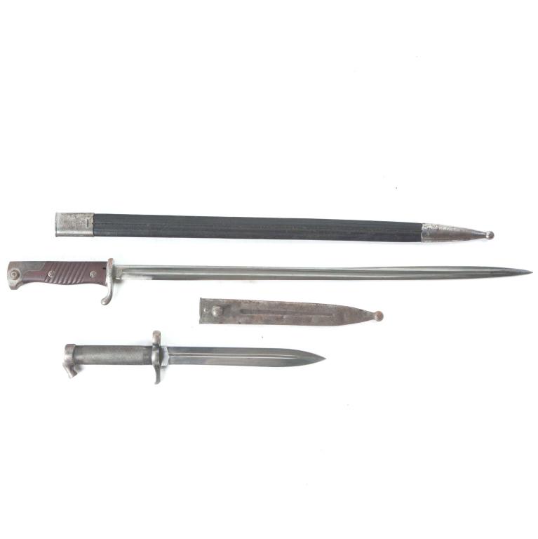 TWO EUROPEAN BAYONETS: TWO EUROPEAN BAYONETS. Twentieth century. Larger marked "Simson and Co., Suhl", with walnut grips leather sheath, and s/n. 18984, 27"l., and a Swedish military bayonet numbered 345, 14"l.