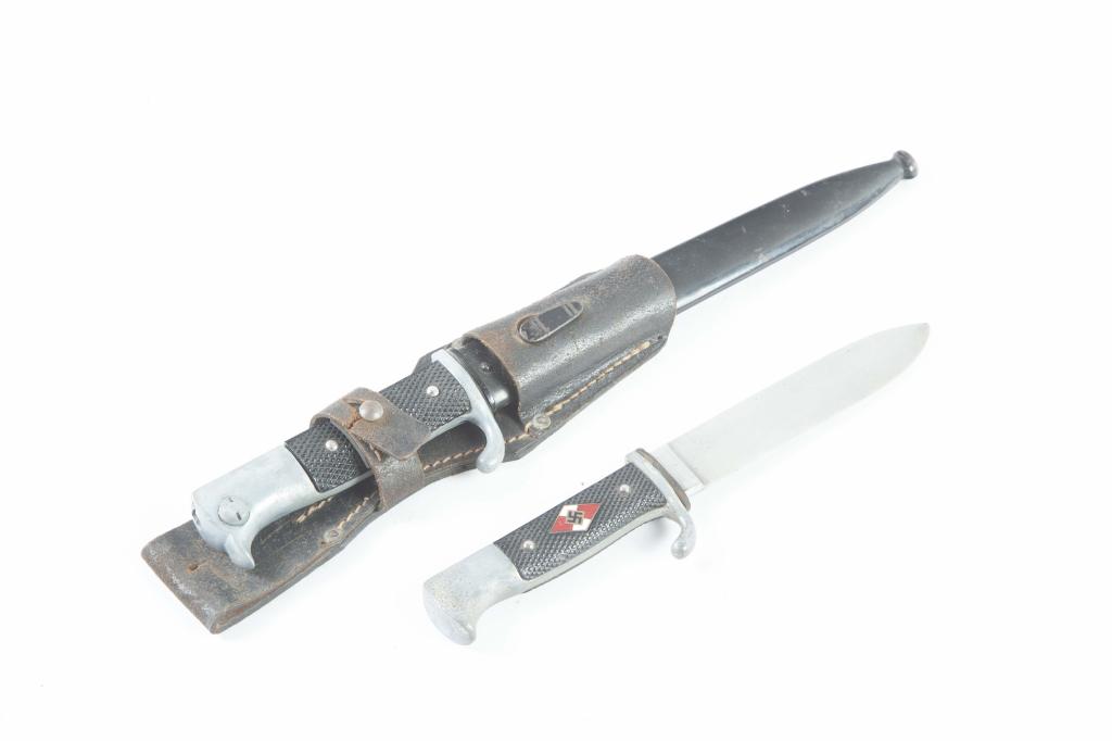 TWO GERMAN WWII BLADES: TWO GERMAN WWII BLADES. Second quarter-20th century. Bayonet with checkered hard rubber grips, leather belt holster, and metal sheath, 14.75"l., and a M7/S6 RZM dagger with checkered grips, and swasti