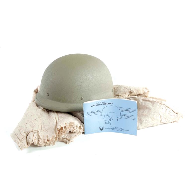KEVLAR FRITZ-STYLE PROTOTYPE BALLISTIC HELMET: KEVLAR FRITZ-STYLE PROTOTYPE BALLISTIC HELMET. American, 20th century. Unused kevlar helmet with nylon chin-strap. Includes original batting.